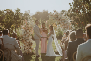 Bride and groom look at their wedding guests during ceremony