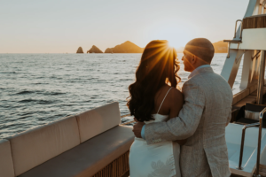 Bride and groom overlook ocean