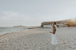 Bride and groom enjoying cocktails at the beach