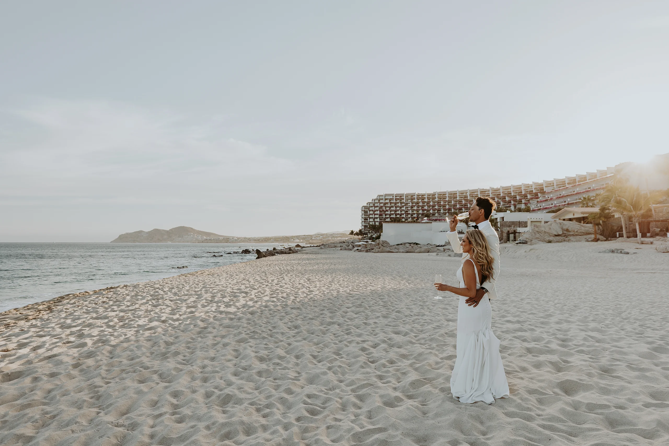 Bride and groom enjoying cocktails at the beach