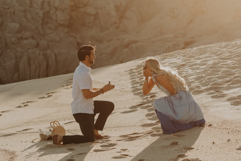 woman holds her hands over her mouth, she is surprised he is proposing