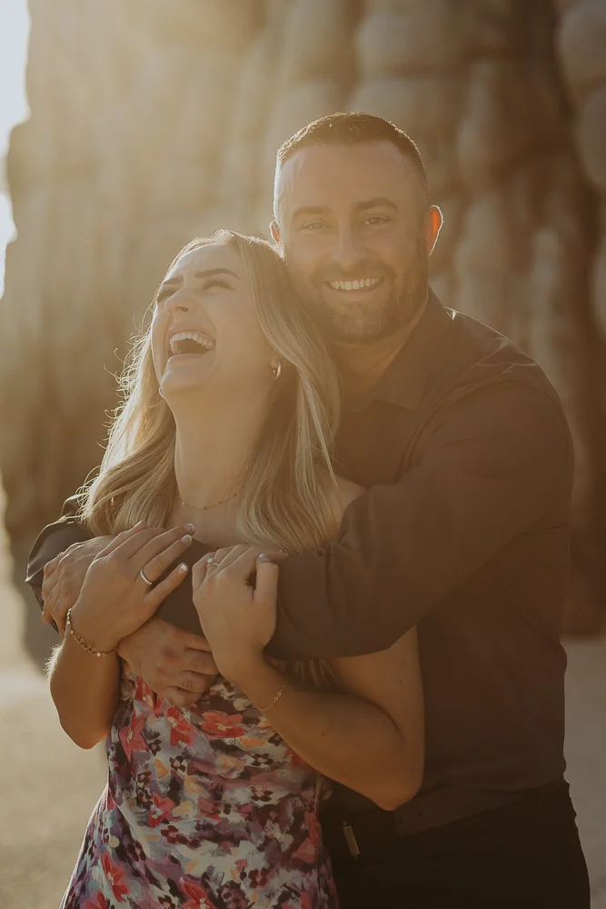 couple is laughing with sunset at the beach