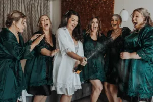 Sandos Cabo wedding photo; bridesmaids with champagne