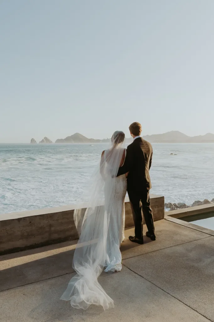 bride and groom overlook iconic Arch landmark of Cabo