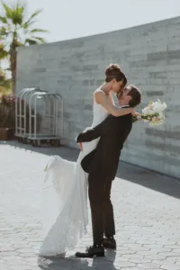 groom picks up bride for photography session