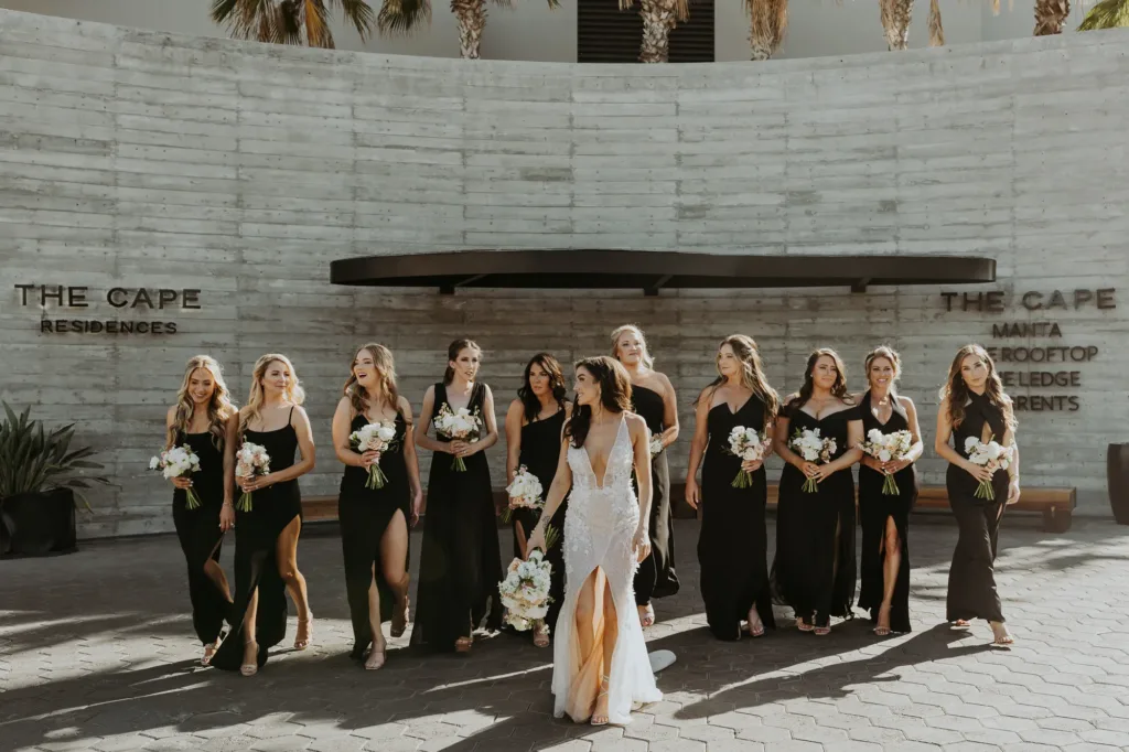 bride and bridesmaids walking with their gowns and bouquets