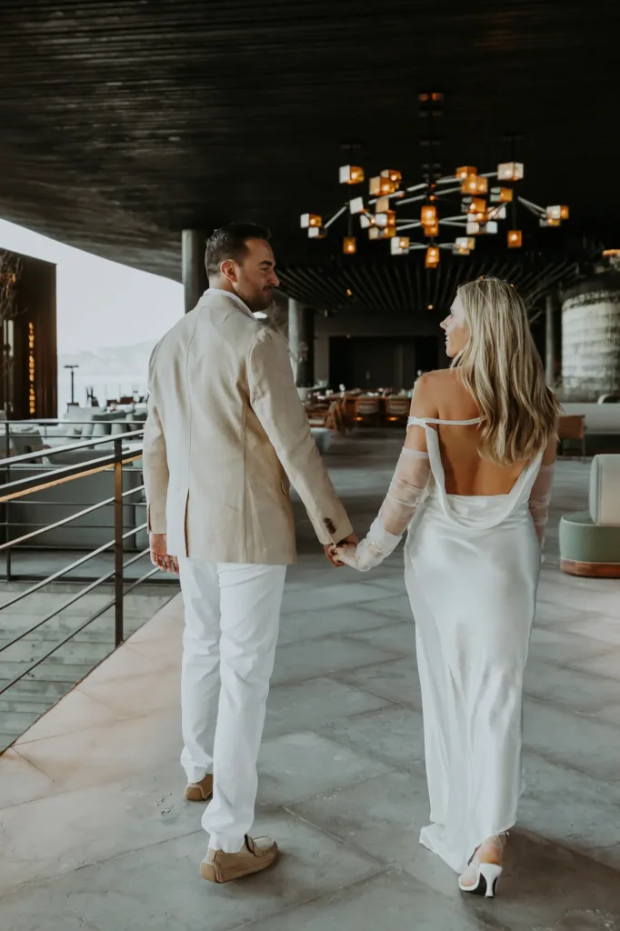 Bride and groom walk towards the sunken bar at The Cape