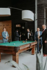 groom and friends play pool