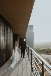 bride and groom walk towards their beach ceremony