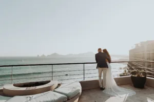 newlyweds admire the ocean view at one of The Cape villas