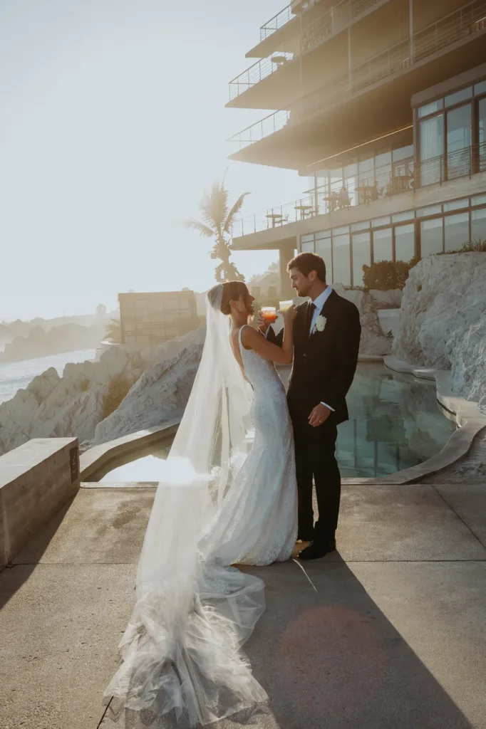 Bride and groom toasting at the swimming pool of The Cape Hotel
