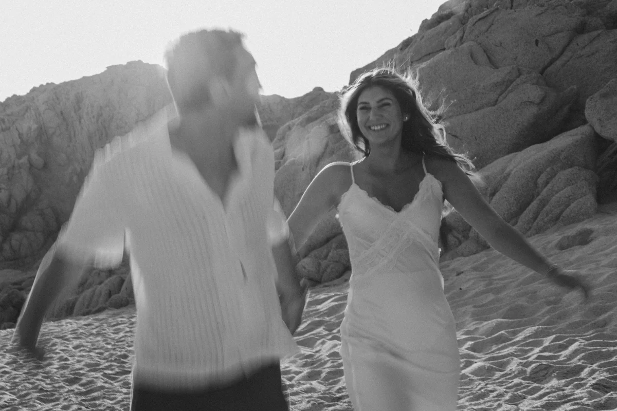 Couple running at the beach during photo session