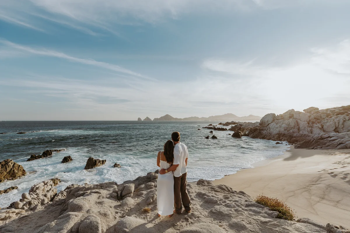 couple overlooking Los Cabos landmark with the ocean