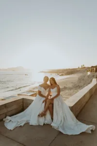 Newlywed LGBTQ+ couple during sunset with golden hour light at the beach