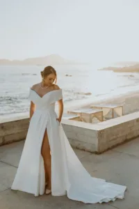 Bride with wedding gown at the ledge of The Cape hotel with the ocean in the background