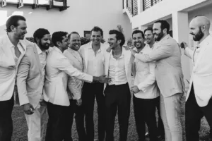 Groom with groomsmen laughing together