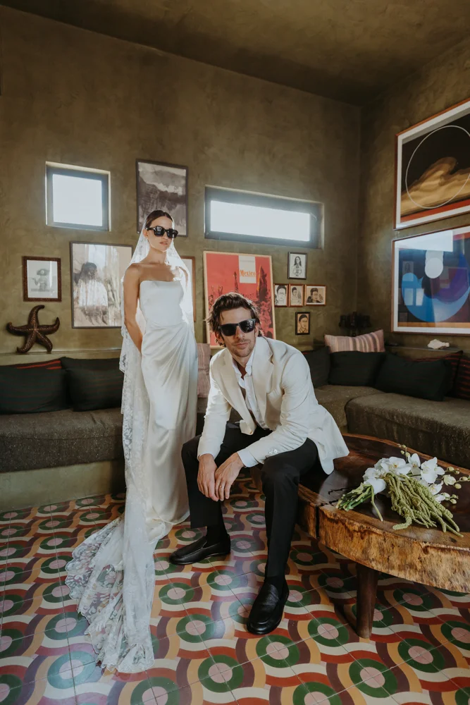 Bride and groom editorial shot, they are wearing sunglasses and looking cool