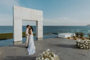Bride and groom next to the ocean at Le Blanc Resort