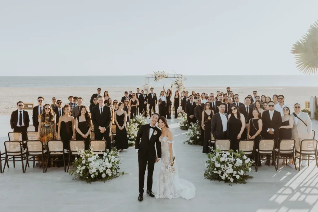 Bride and groom pose with their guests after ceremony