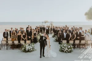 Bride and groom pose with their guests after ceremony