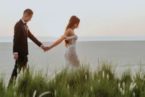 Bride and groom walking at the beach after their Nobu wedding