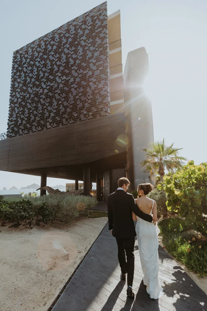 Bride and groom walk towards The Cape Hotel