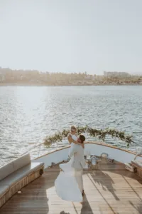 Groom picks up bride at yacht wedding with the ocean in the background
