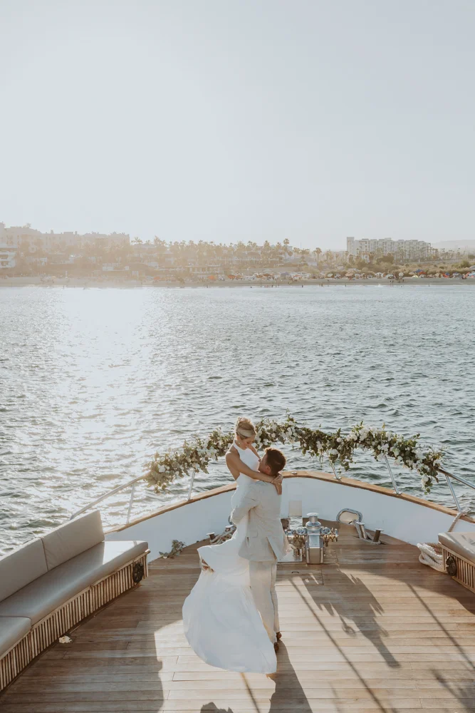 Pelican Yacht wedding Groom picks up bride at yacht wedding with the ocean in the background