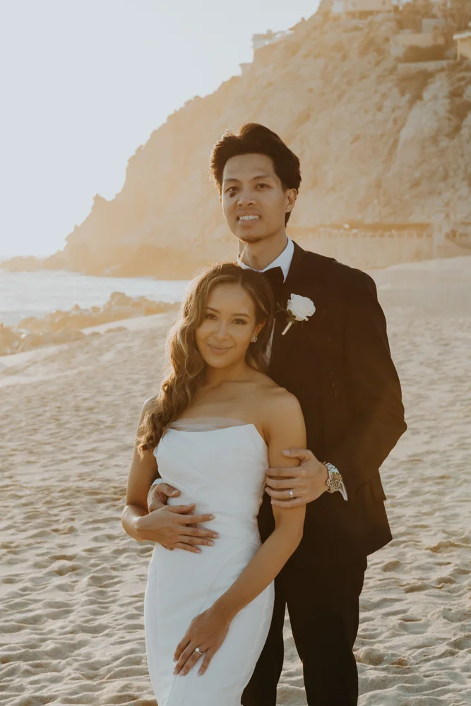 Bride and groom smile to the camara for a classic portrait